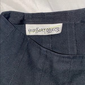 Pleated black skirt with brown buttons